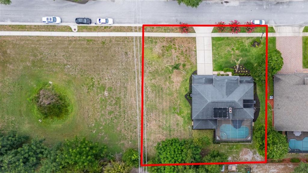 An aerial view shows a house with a pool on a lot outlined in red — 663 CHARRICE PLACE, SANFORD, FL