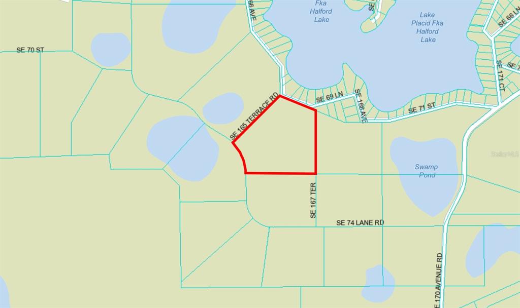 This is a map showing a highlighted parcel of land near a lake and pond — SE 74TH LANE ROAD UNIT 6-EAST, OCKLAWAHA, FL