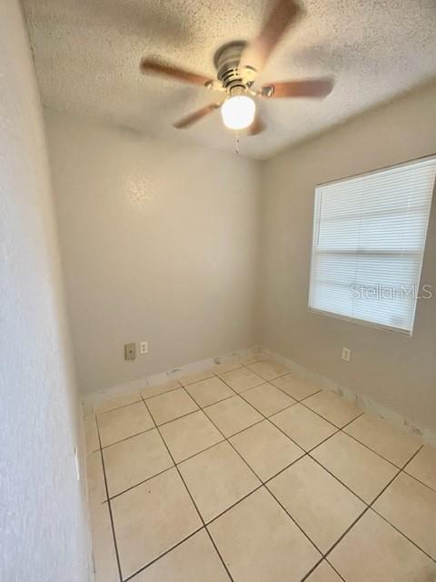 A small room with beige tile flooring, a ceiling fan, and a window with blinds — 730 WYMAN COURT UNIT 730, ORLANDO, FL