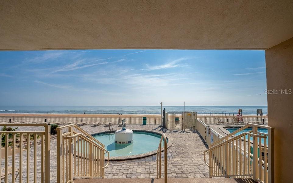 A bedroom features a blue wall decorated with three surfboard-shaped wall hangings above a bed — 219 S ATLANTIC AVENUE UNIT 403, DAYTONA BEACH, FL
