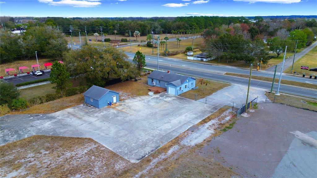 An aerial view shows a blue house and a detached garage on a paved lot — 4604 OLD GOLDENROD ROAD, ORLANDO, FL