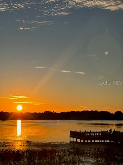 A sunset over a lake with a wooden pier in the foreground — 13 NW BUENA VISTA ROAD, DUNNELLON, FL