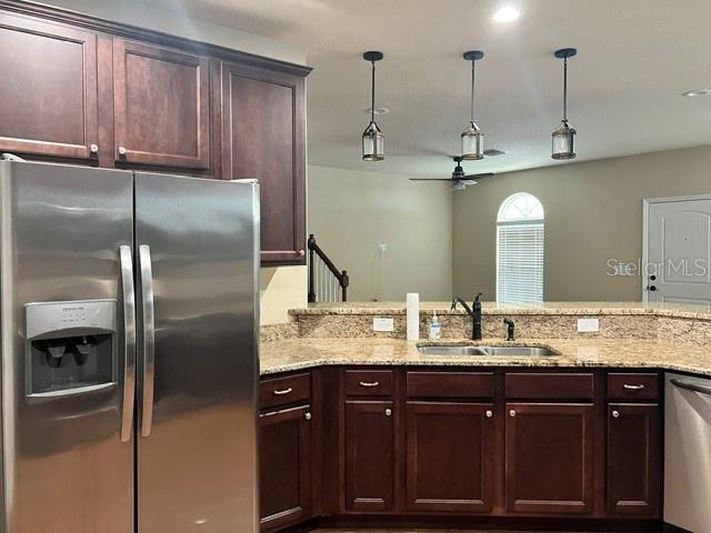 A kitchen features dark wood cabinets, stainless steel appliances, and granite countertops — 421 E PARK STREET, LAKELAND, FL