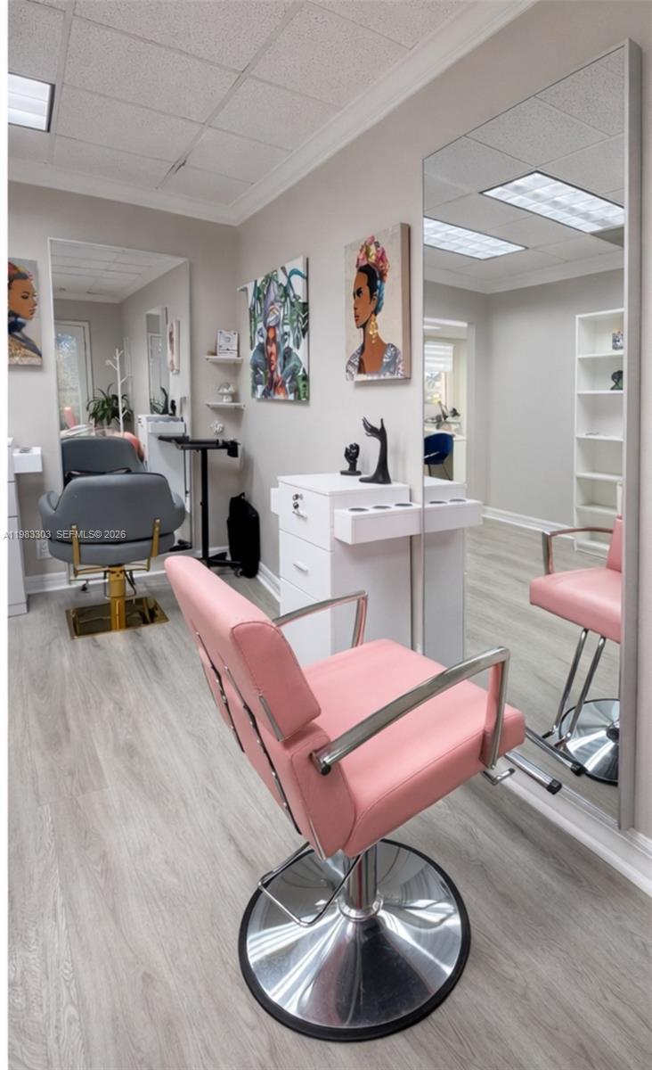 A salon room features two styling chairs, a white storage cabinet, and a large wall mirror — 2100 E Hallandale Beach Blvd, Hallandale Beach FL 33009, HALLANDALE BEACH, FL