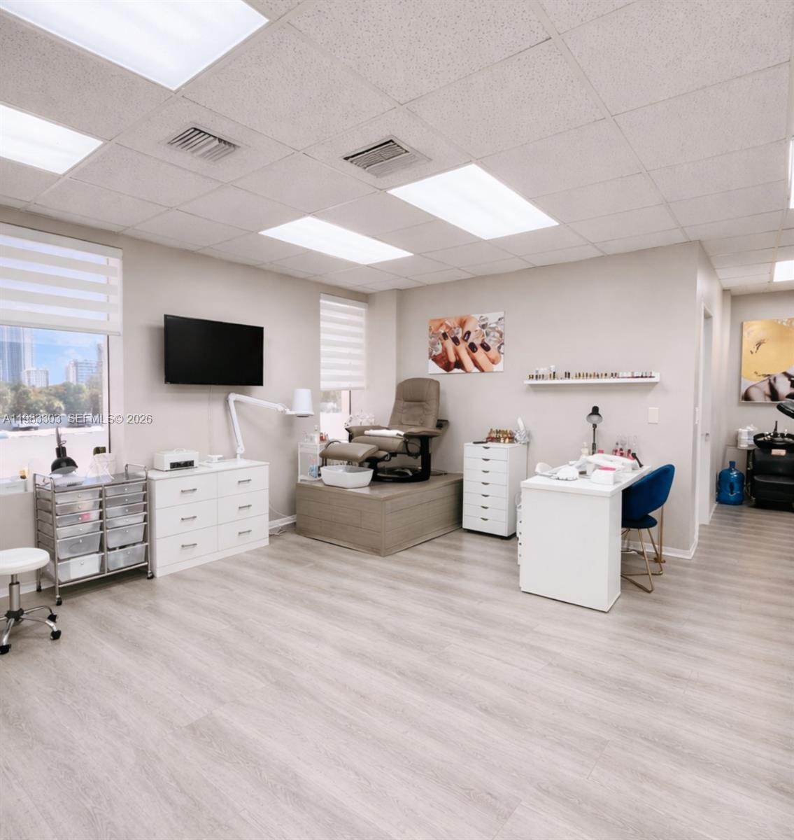 A bright salon room features a pedicure station, manicure desk, and light wood flooring — 2100 E Hallandale Beach Blvd, Hallandale Beach FL 33009, HALLANDALE BEACH, FL
