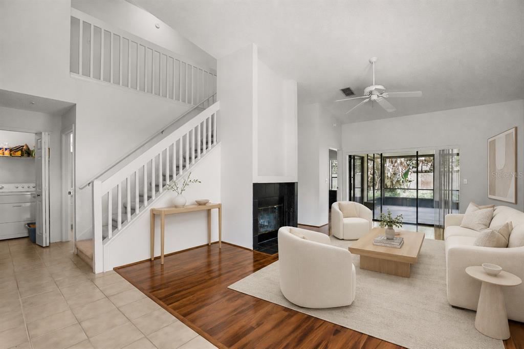 A living room features a fireplace, a staircase, and a sliding glass door to a patio — 223 HERON STREET, ALTAMONTE SPRINGS, FL