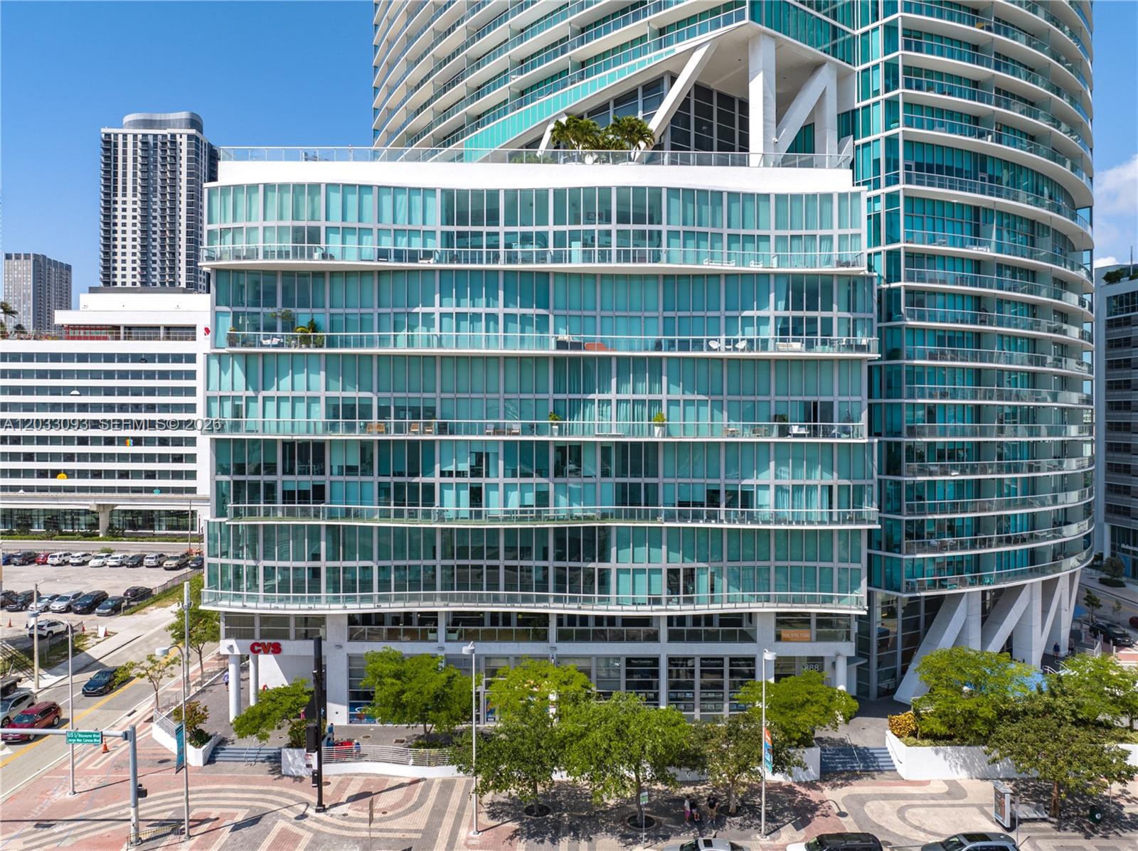 An exterior view of a modern high-rise building with a CVS pharmacy on the ground floor — 888 Biscayne Blvd, Miami FL 33132, MIAMI, FL