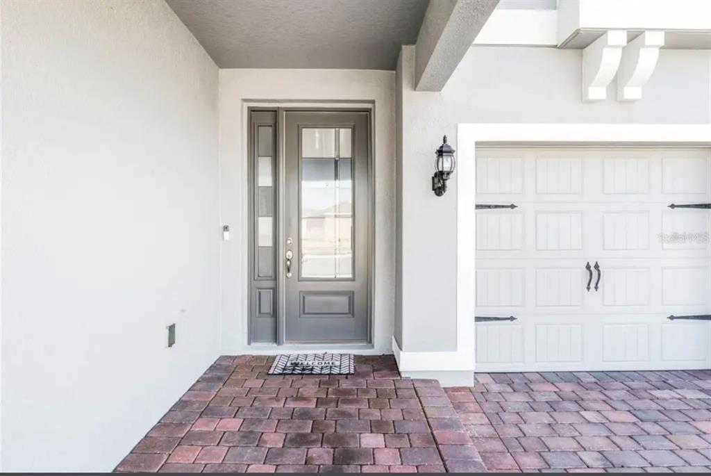 A front entryway features a gray door with a sidelight, a brick porch, and a garage — 826 TERRAPIN DRIVE, DEBARY, FL