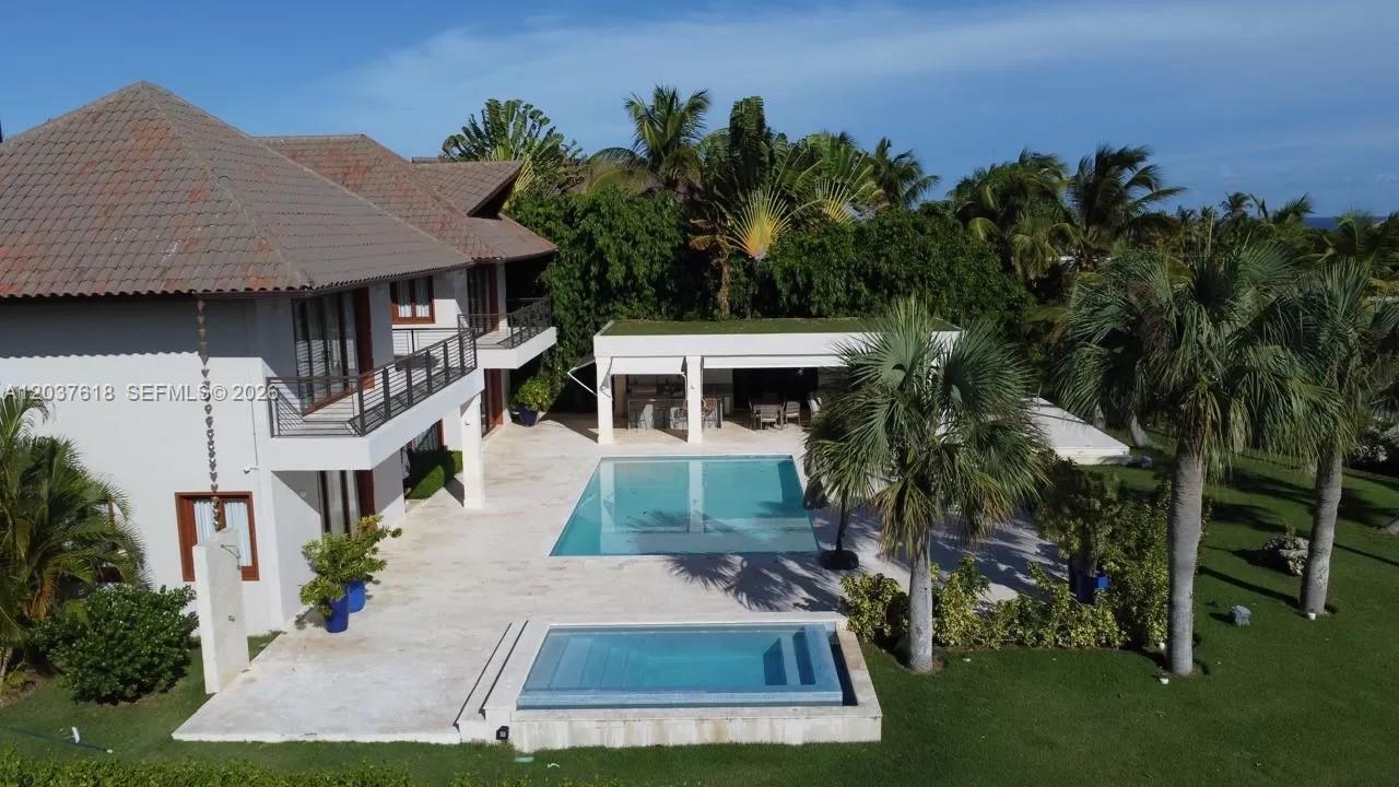 An aerial view shows a two-story house with a pool, spa, and covered patio — 0 La Palmas, FL, FL