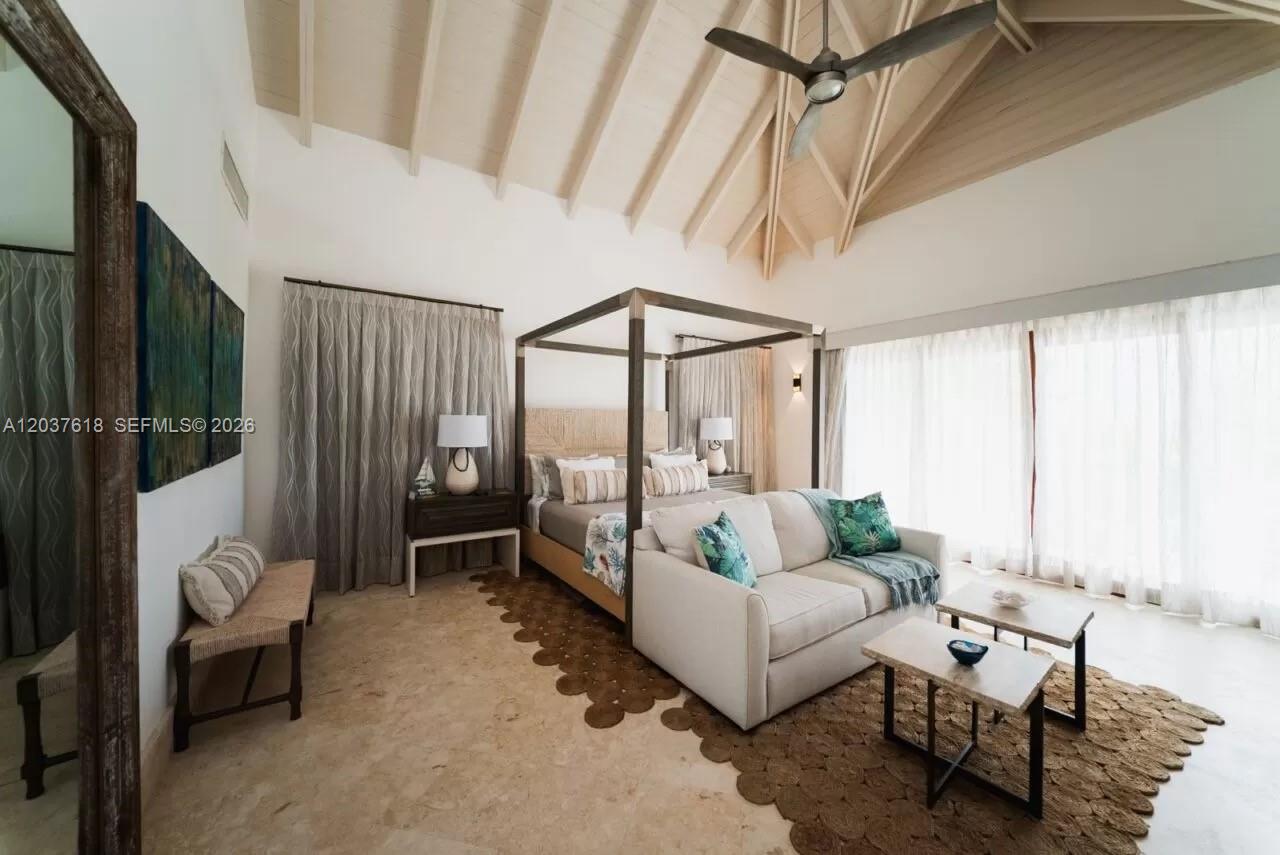 A bedroom features a four-poster bed, a sofa, and a high vaulted ceiling — 0 La Palmas, FL, FL