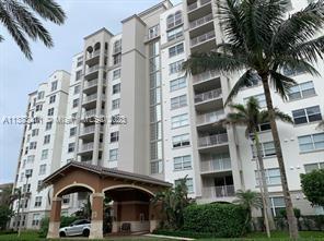 A multi-story residential building with balconies and a covered entrance driveway under a cloudy sky — 3606 S Ocean Blvd # 504, Highland Beach FL 33487, HIGHLAND BEACH, FL