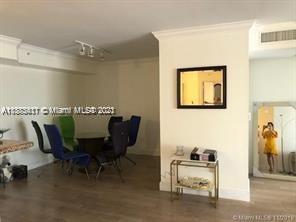 A dining area with a glass table and chairs next to a wall with a mirror — 3606 S Ocean Blvd # 504, Highland Beach FL 33487, HIGHLAND BEACH, FL