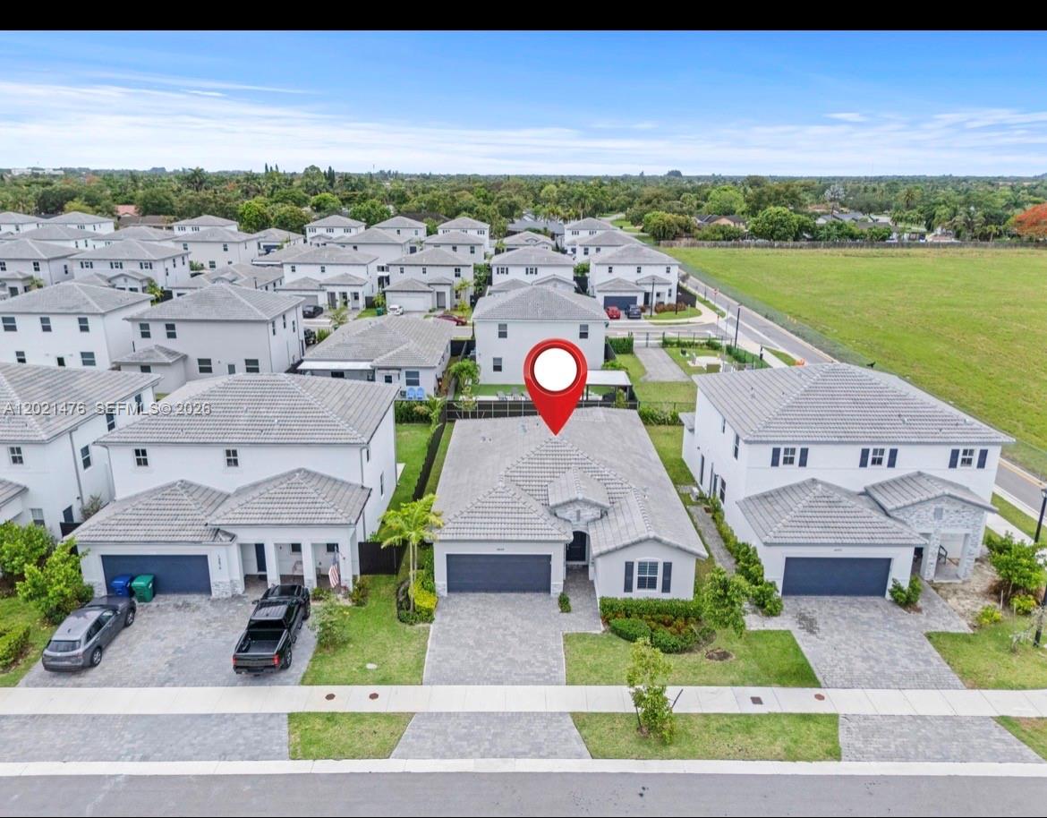 An aerial view shows a single-story suburban house with a gray tile roof and driveway — 14884 SW 162nd St, Miami FL 33187, MIAMI, FL