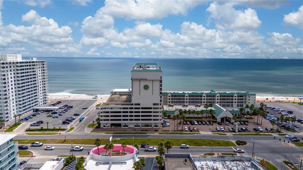 An aerial view shows a large beachfront hotel complex with parking lots and the ocean — 2700 N ATLANTIC AVENUE UNIT 821, DAYTONA BEACH, FL