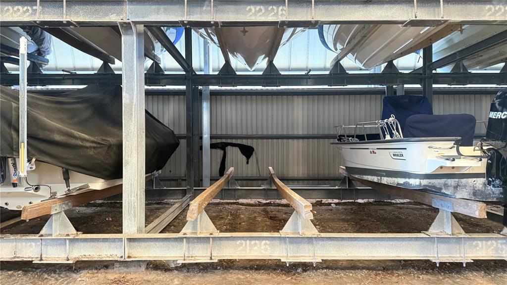 Boats are stored in a multi-level metal rack structure within a covered boat storage facility — 408 GULF OF MEXICO DRIVE UNIT 2126, LONGBOAT KEY, FL