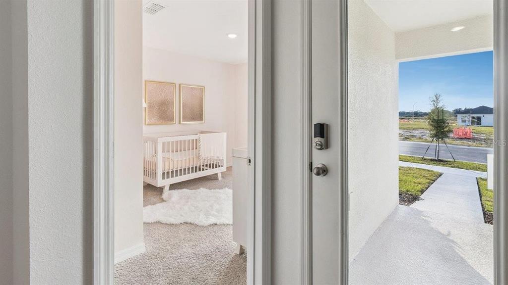 A view from a doorway looking into a nursery and out toward a suburban street — 1126 AMBERS WAVE COURT, LAKE WALES, FL