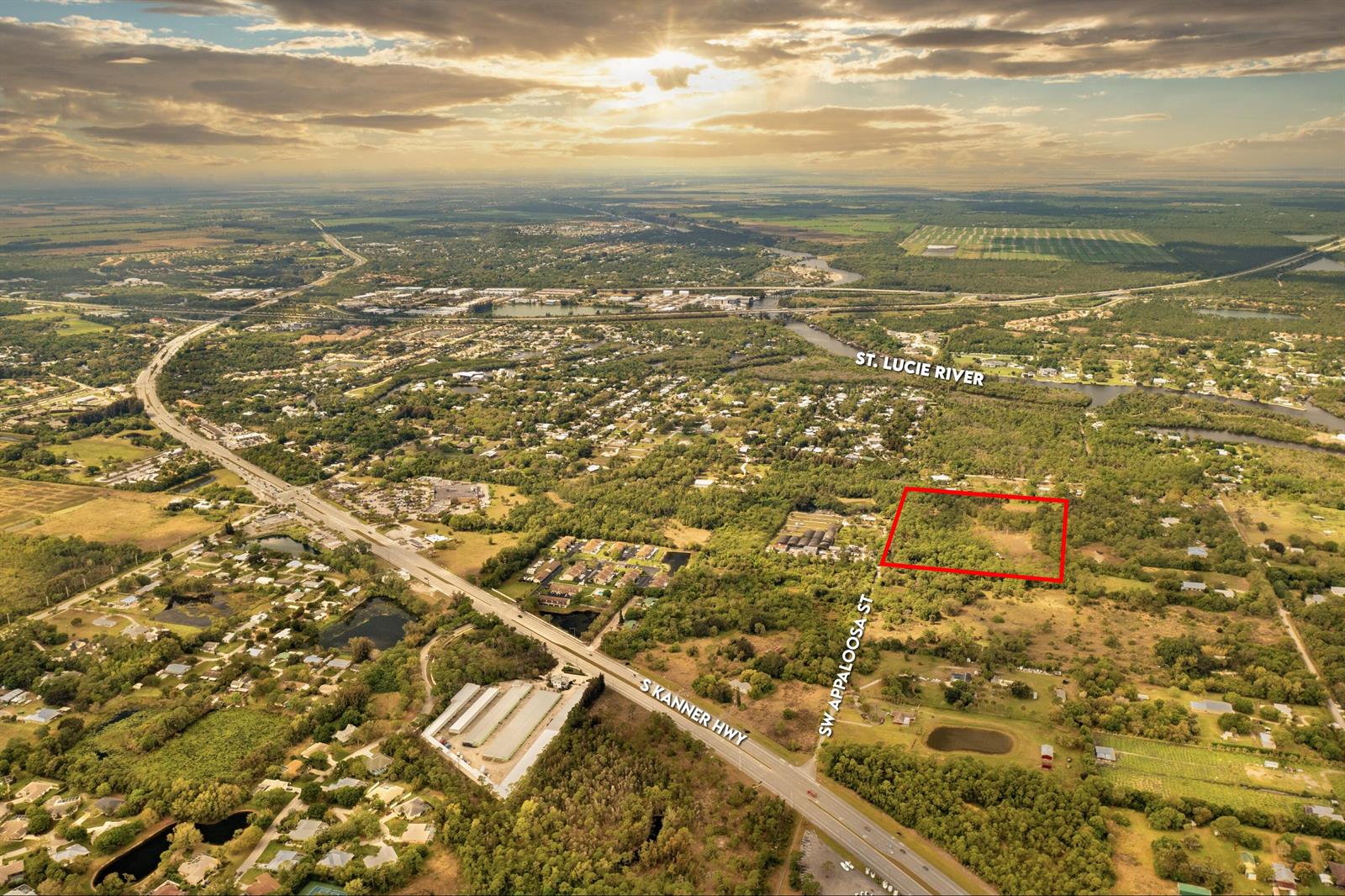 An aerial view shows a rectangular plot of land outlined in red near a highway — 223 SW Appaloosa Street, Stuart FL 34997, STUART, FL