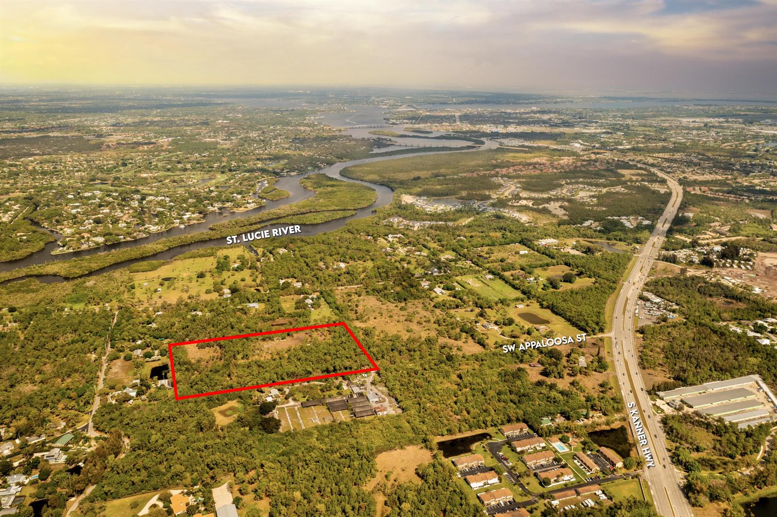 An aerial view shows a rectangular plot of land outlined in red near a highway — 223 SW Appaloosa Street, Stuart FL 34997, STUART, FL