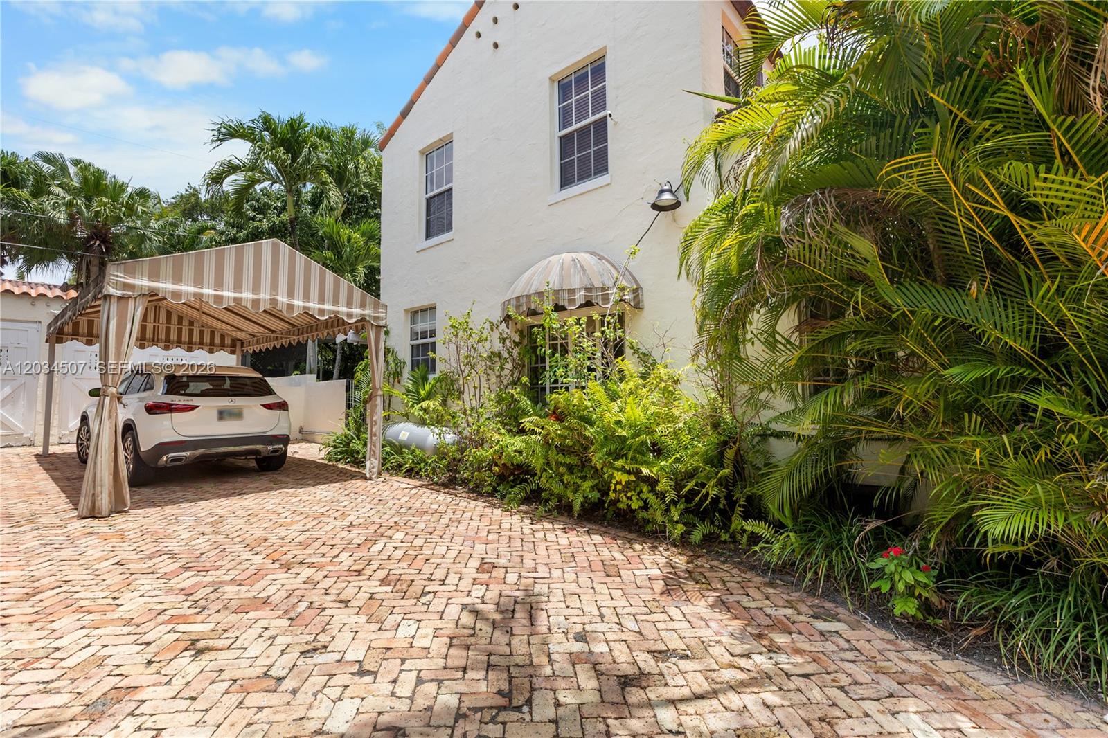 A white two-story house with a striped carport and a brick driveway — 1511 SW 13th St, Miami FL 33145, MIAMI, FL