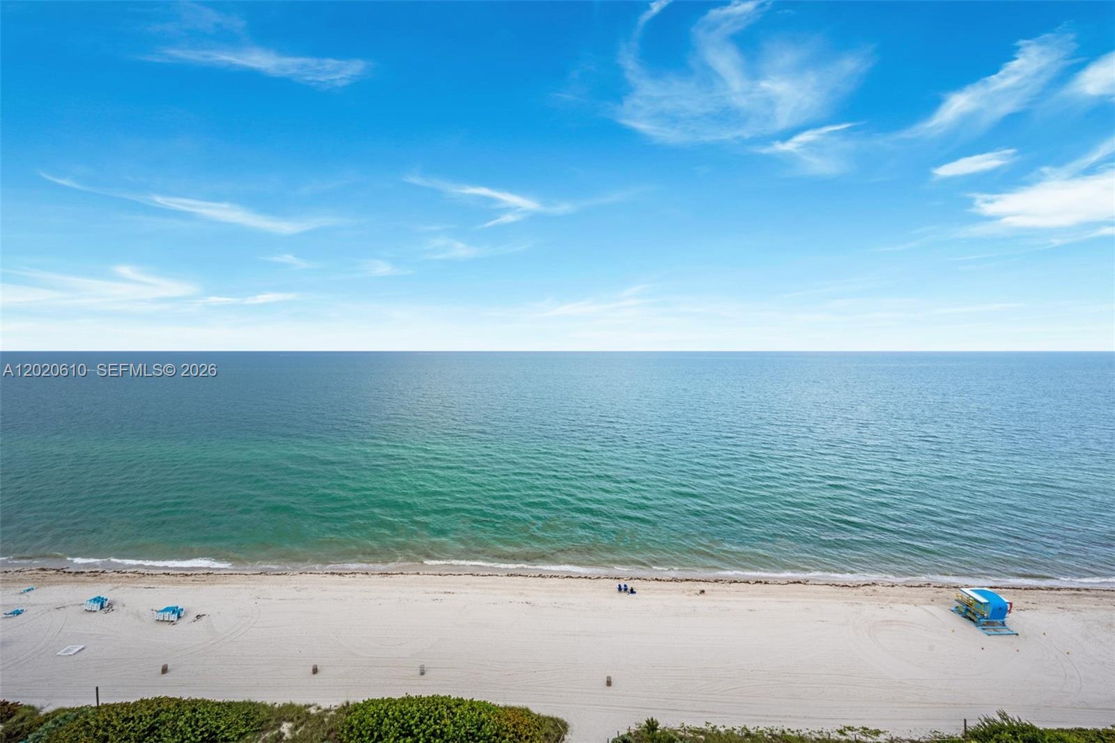 An elevated view of a sandy beach with a lifeguard stand and the ocean — MIAMI BEACH, FL