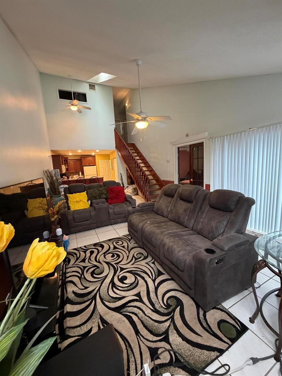 A kitchen features wood cabinets, speckled laminate countertops, a white stove, and a white refrigerator — 2035 Winners Circle, North Lauderdale FL 33068, NORTH LAUDERDALE, FL