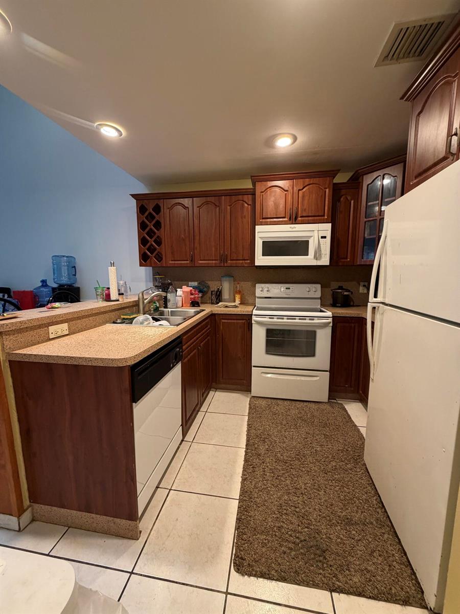 An empty room with orange walls, white tile floors, a ceiling fan, and a closet — 2035 Winners Circle, North Lauderdale FL 33068, NORTH LAUDERDALE, FL