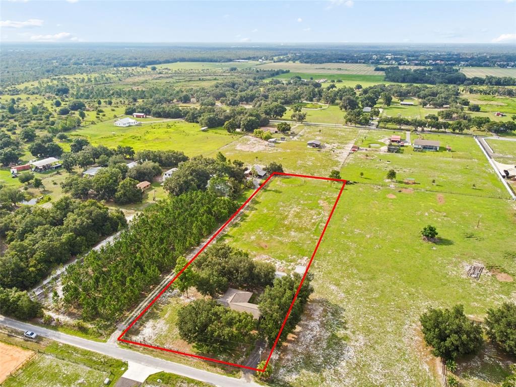 An aerial view shows a house on a rectangular lot outlined in red — 336 CORBETT ROAD, LITHIA, FL