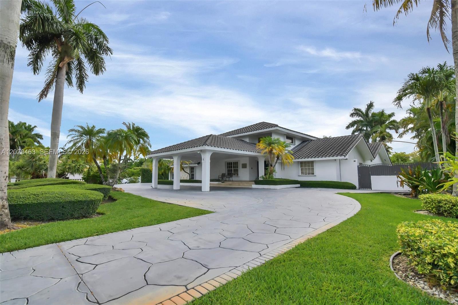 A white house with a tiled roof and a large stone-patterned driveway — 3401 SW 129th Ave, Miami FL 33175, MIAMI, FL