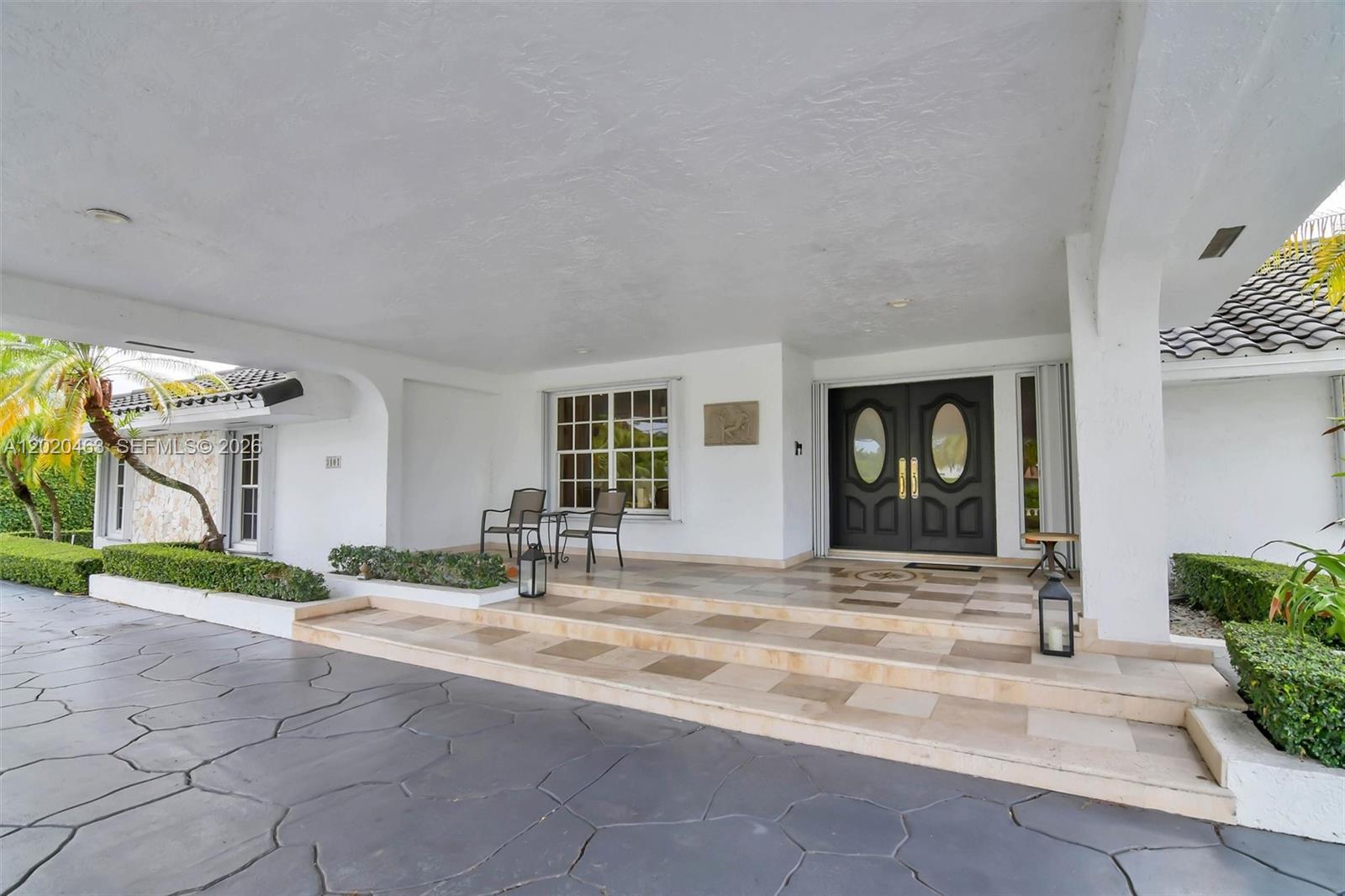 A covered entryway features a paved driveway, tiled steps, and double doors with oval windows — 3401 SW 129th Ave, Miami FL 33175, MIAMI, FL
