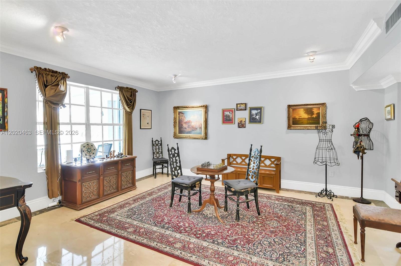 A living room features a chess table, ornate chairs, a large rug, and wall art — 3401 SW 129th Ave, Miami FL 33175, MIAMI, FL