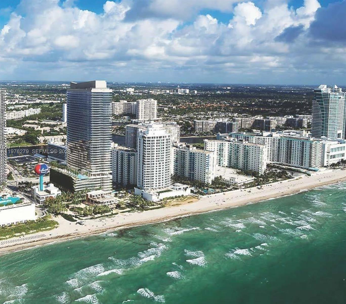 An aerial view shows high-rise buildings along a sandy beach and the ocean — 4111 S Ocean Dr # 3704, Hollywood FL 33019, HOLLYWOOD, FL