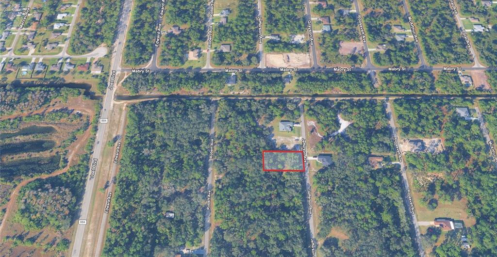 An aerial map view shows a rectangular plot of land outlined in red near Jefferson Avenue — 1915 JEFFERSON AVENUE, LEHIGH ACRES, FL
