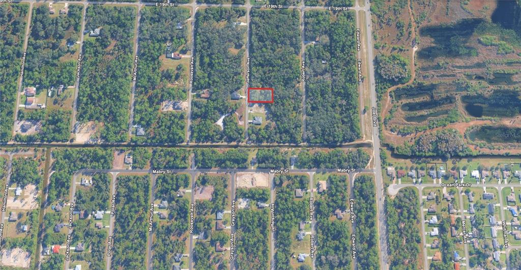 This is an aerial map showing a rectangular lot outlined in red on a street — 1915 JEFFERSON AVENUE, LEHIGH ACRES, FL