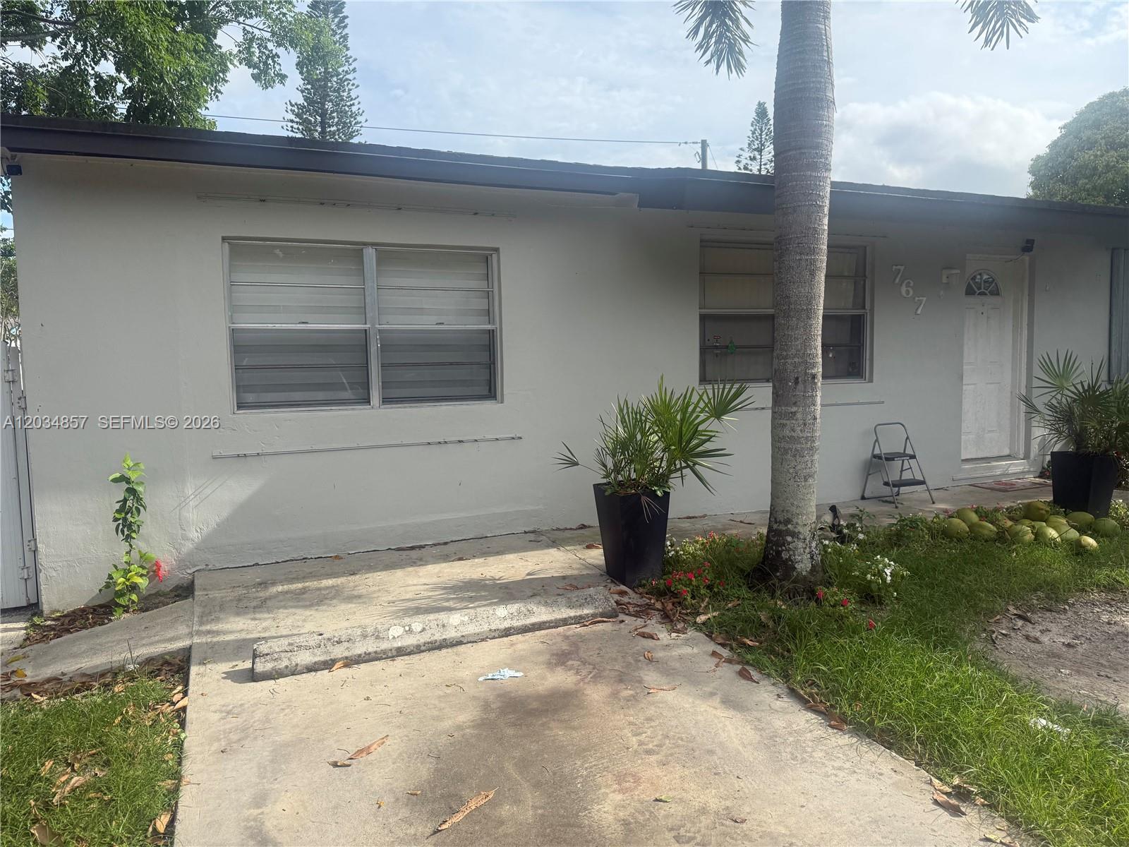 A kitchen features white cabinets, a stainless steel stove, and a double-basin sink — 767 SW 5th Ter, Florida City FL 33034, FLORIDA CITY, FL