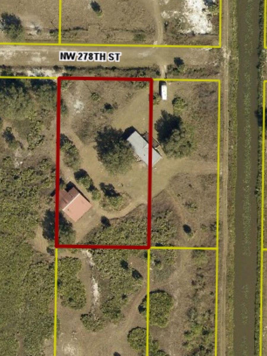 An aerial view shows a rectangular property lot containing two buildings and a dirt driveway — 18420 NW 278 Street, Okeechobee FL 34972, OKEECHOBEE, FL