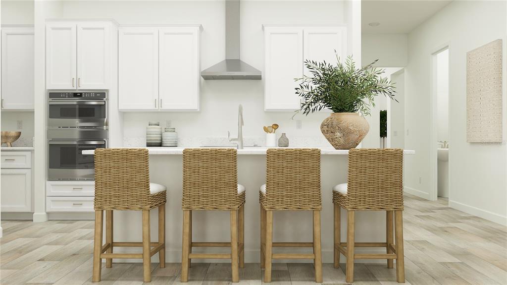 This rendering shows a modern kitchen with white cabinetry, a center island, and wicker stools — 9091 MINNOW RAY DRIVE, LAND O LAKES, FL
