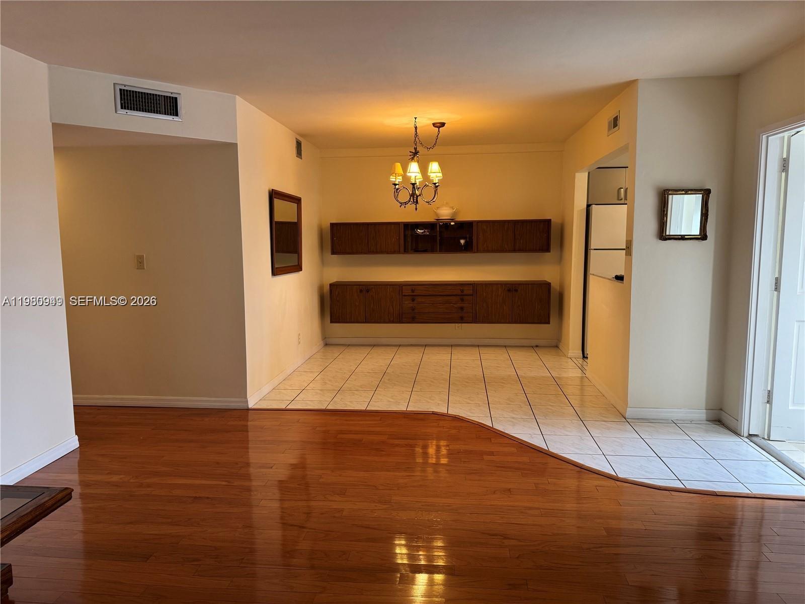 A rectangular swimming pool sits in front of a multi-story apartment building with balconies — 100 SE 6th Ave # 207, Pompano Beach FL 33060, POMPANO BEACH, FL