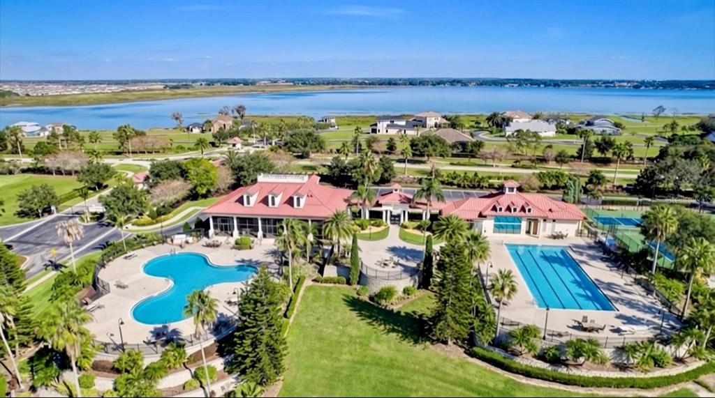 An aerial view shows a community clubhouse with two swimming pools and a tennis court — 103 BLAZING STAR AVENUE, LAKE ALFRED, FL