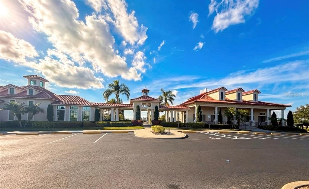 A large, single-story clubhouse building with a red tile roof and a parking lot — 103 BLAZING STAR AVENUE, LAKE ALFRED, FL