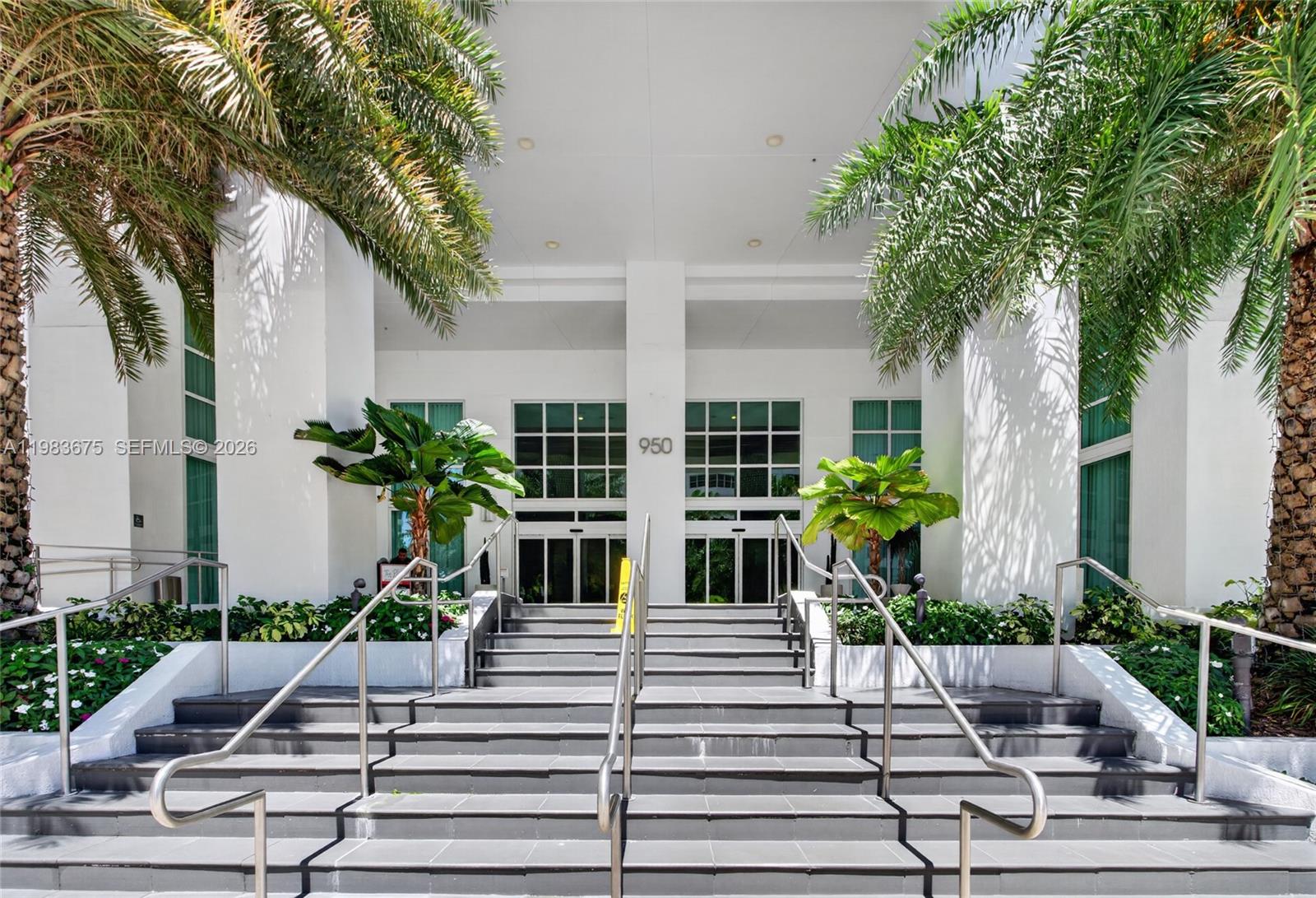 The exterior entrance features a wide set of gray stairs leading to glass double doors — 950 Brickell Bay Dr # 4100, Miami FL 33131, MIAMI, FL