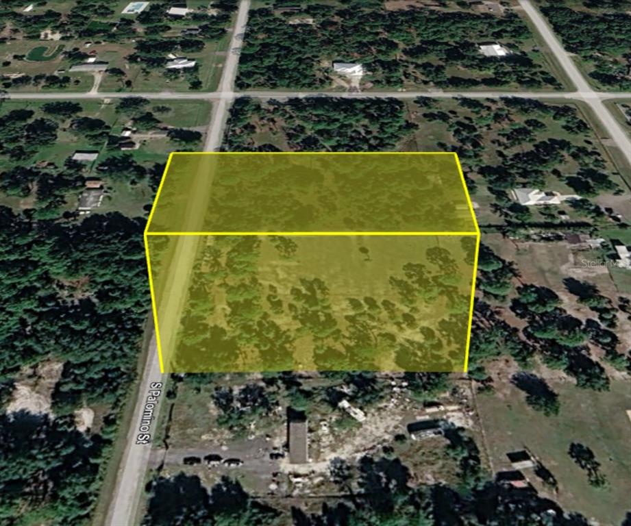 An aerial view shows a rectangular plot of land highlighted in yellow along a road — 345 S PALOMINO STREET, CLEWISTON, FL