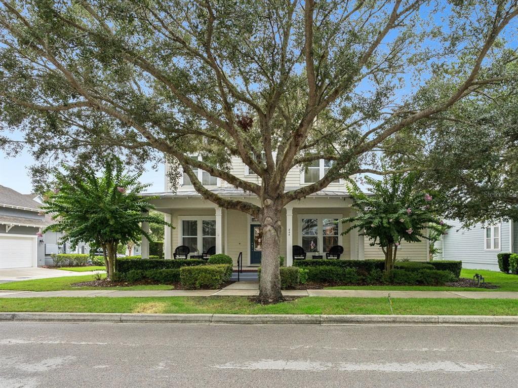 A two-story house with a front porch and a large tree in the yard — 844 OAKLAND PARK BOULEVARD, WINTER GARDEN, FL
