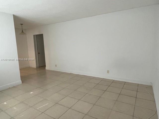 An empty room with white walls and light-colored square floor tiles — 2212 Liberty St # 1, Hollywood FL 33020, HOLLYWOOD, FL