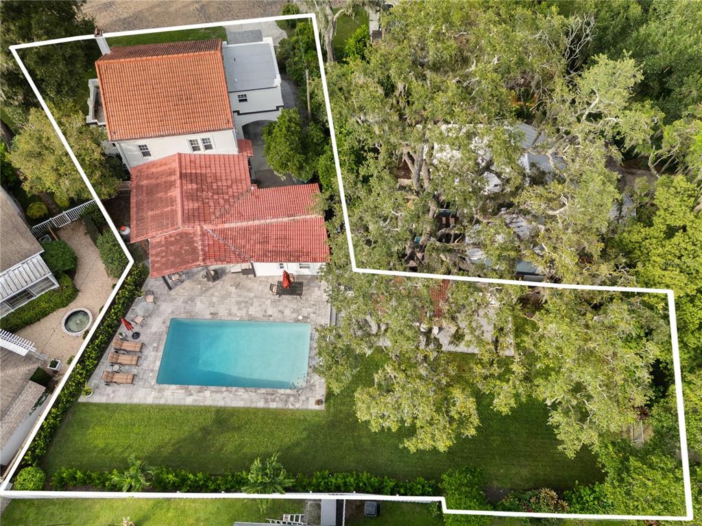 An aerial view shows a house with a red tile roof, swimming pool, and large trees — 1408 E CHURCH STREET, ORLANDO, FL