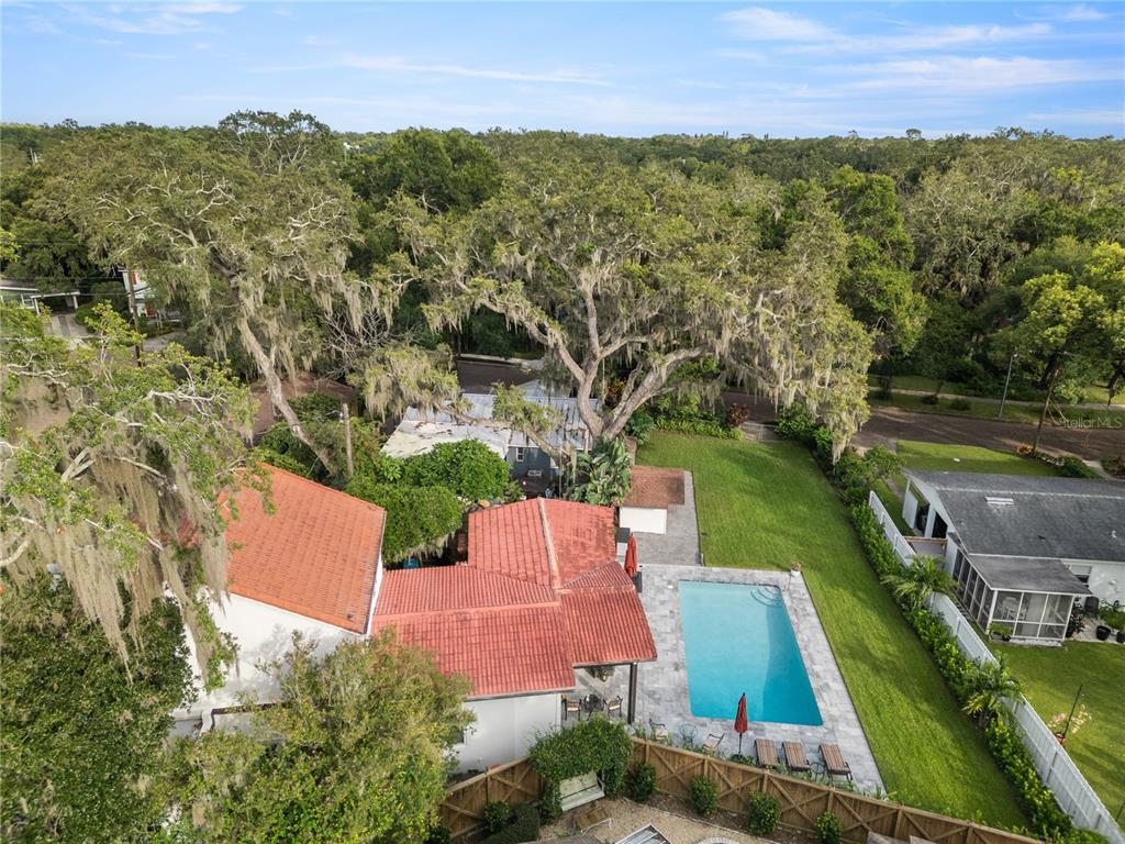An aerial view shows a house with a red tile roof, pool, and large trees — 1408 E CHURCH STREET, ORLANDO, FL