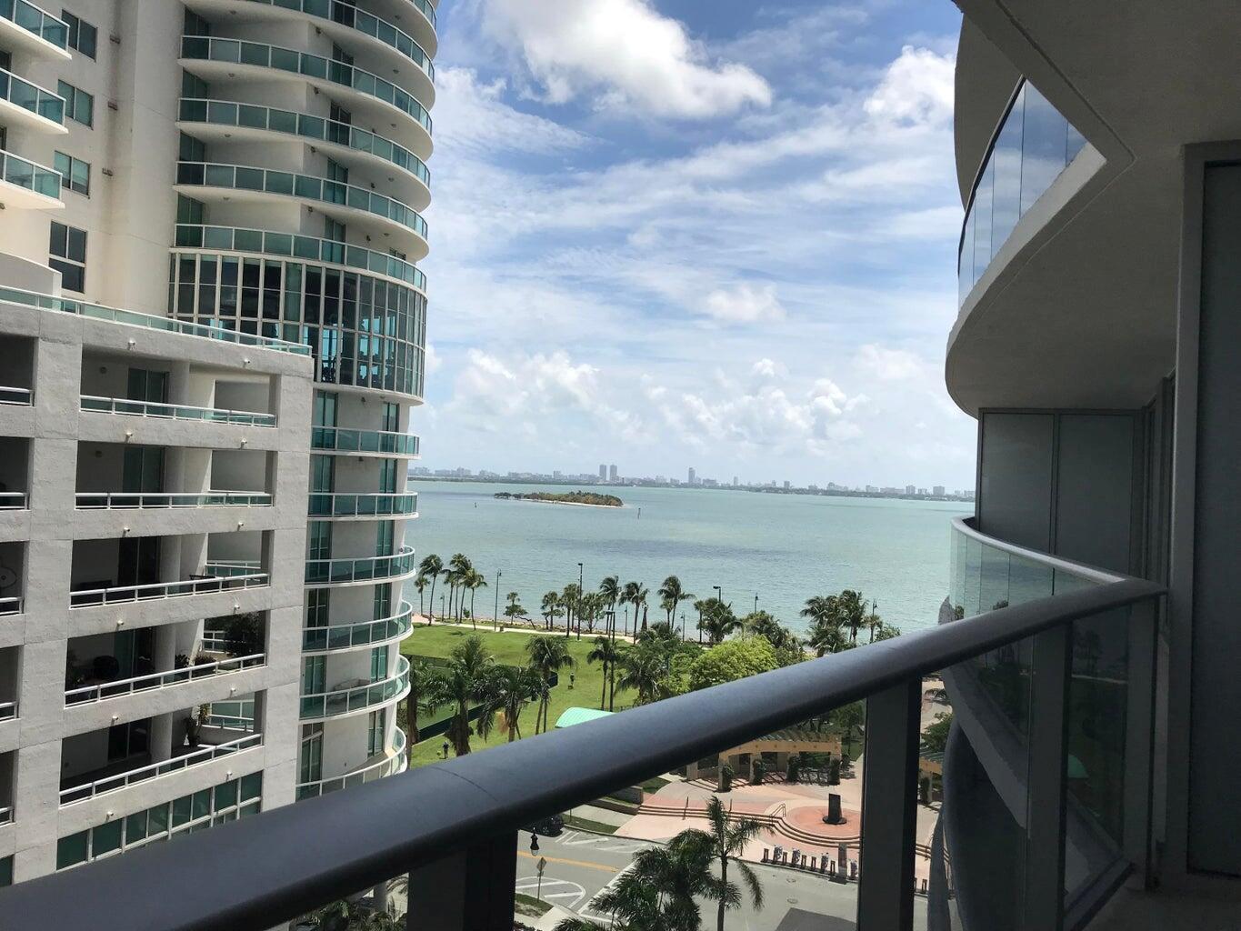 A balcony view overlooking a bay, a park, and neighboring high-rise apartment buildings — 488 NE 18th Street # 807, Miami FL 33132, MIAMI, FL