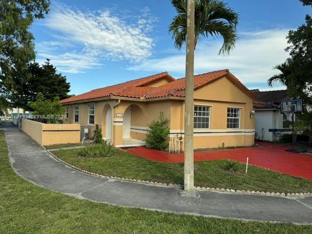 A single-story house with a tan exterior, orange tile roof, and a red driveway — 7599 W 4th Ct # 0, Hialeah FL 33014, HIALEAH, FL
