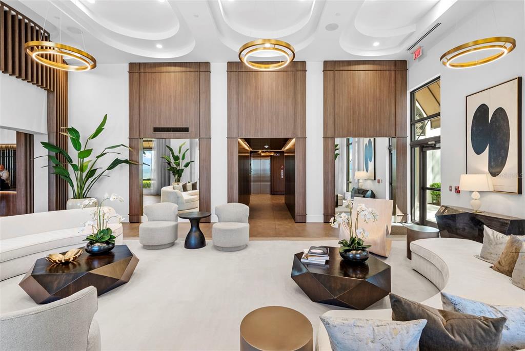 A bedroom features a bed with a quilted cover, a ceiling fan, and a balcony — 2103 BAYSHORE BOULEVARD UNIT 703, TAMPA, FL