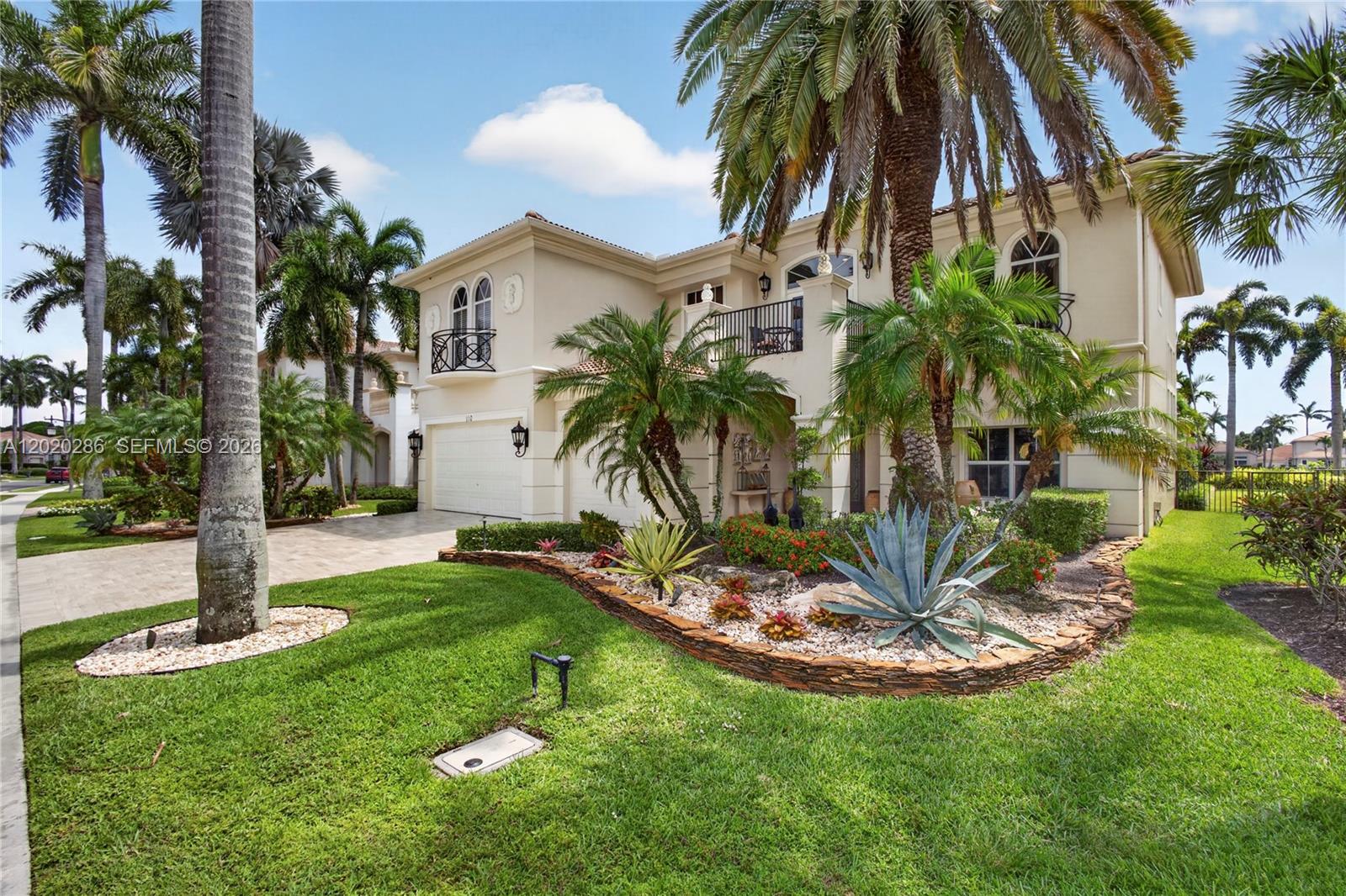 A two-story stucco house features a paved driveway, palm trees, and a landscaped front garden — 110 Abondance Dr, Palm Beach Gardens FL 33410, PALM BEACH GARDENS, FL