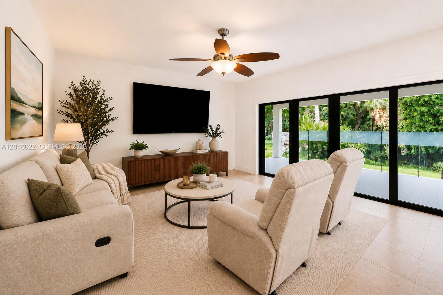 A living room features a sofa, two armchairs, a television, and large glass sliding doors — 26363 SW 152nd Ave, Homestead FL 33032, HOMESTEAD, FL